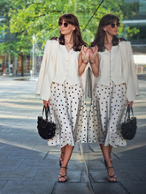 a lady wears a beige worsted wool one button blazer